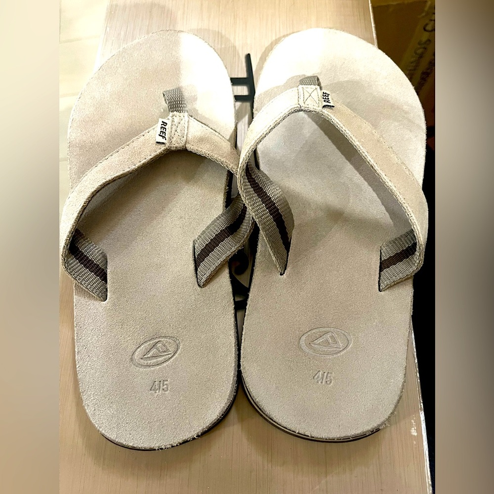 Boys reef flip flops upper leather, shadows in pic. Treads are not worn.